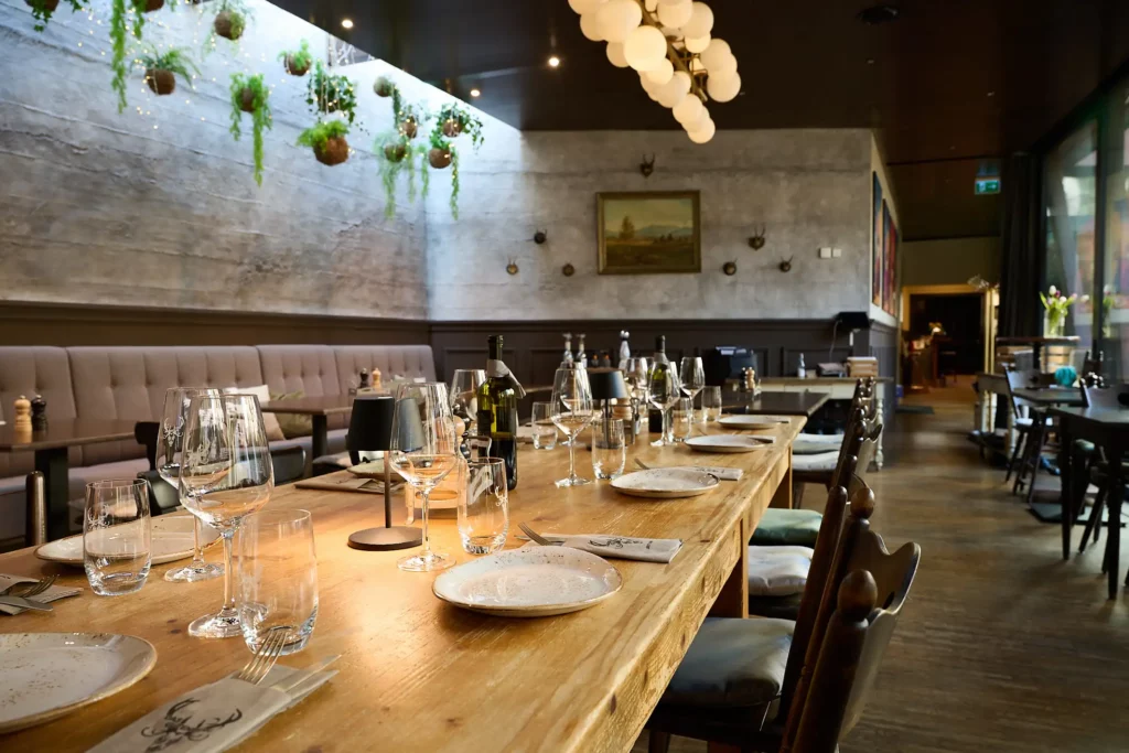 Langer gedeckter Holztisch im Restaurant des Gasthauses Gutenberg